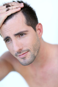 Young man checking hair